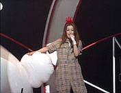 Ami standing next to an inflatable rabbit while singing 'Puffy no Tourmen'